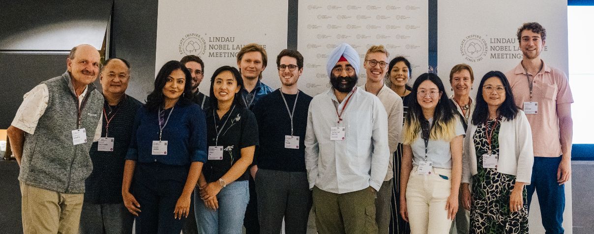 A diverse group of smiling people posing together. 